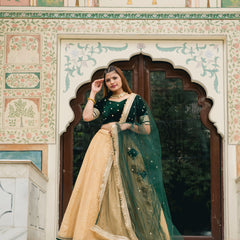 Gold lehenga with green velvet blouse
