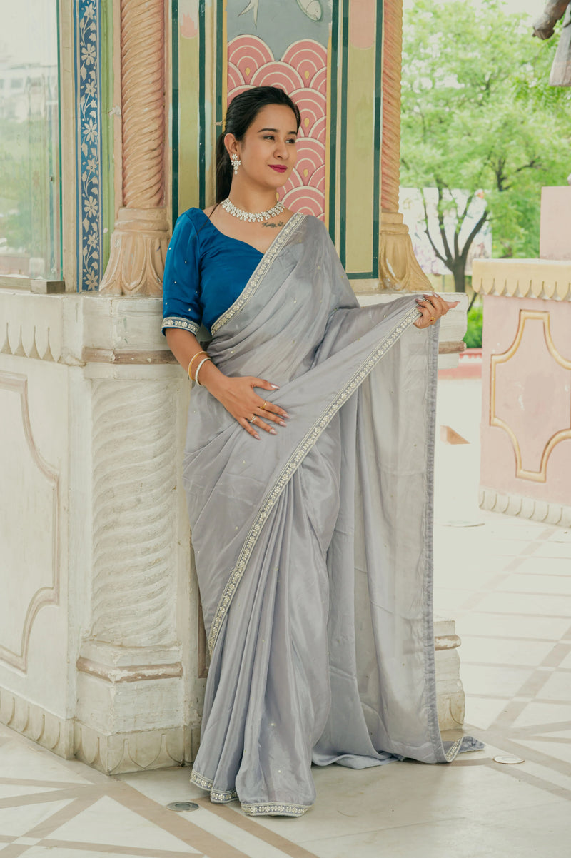 Women wearing grey chinnon saree
