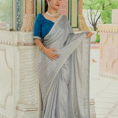 Women wearing grey chinnon saree
