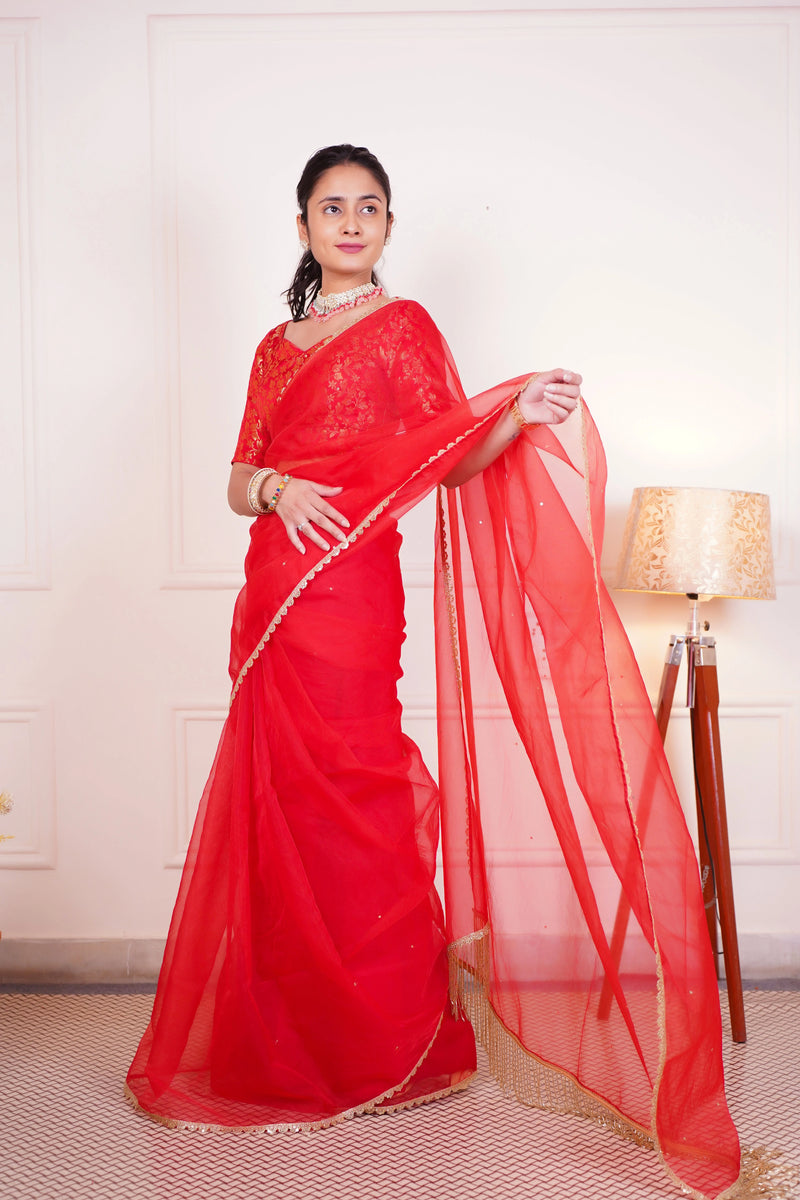 Women wearing red organza wedding saree
