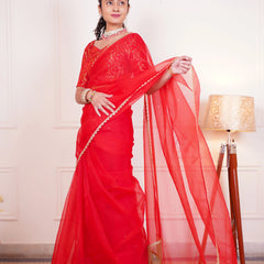 Women wearing red organza wedding saree
